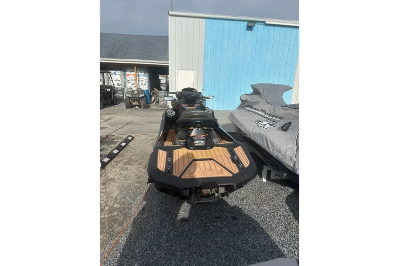 Slide: The Image of 2023 Kawasaki Jetski Ultra 310LX parked outdoors, showcasing rear design. - 7