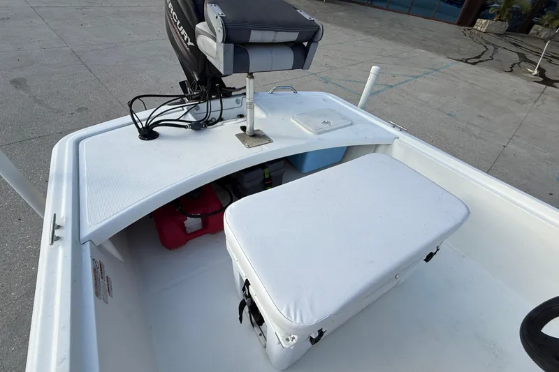 Slide: The Image of 2016 Mako Pro Skiff 17 CC boat interior with seating and storage compartments. - 13