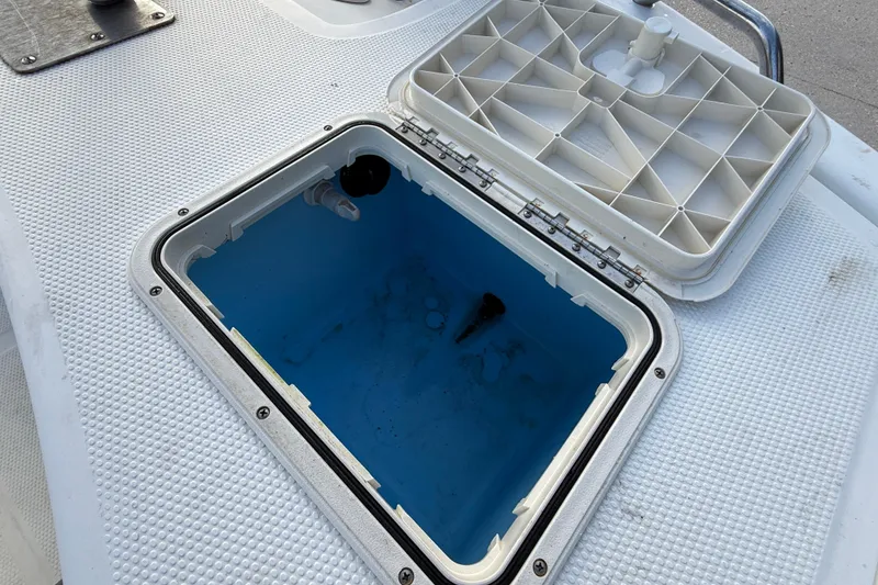 Slide: The Image of Open storage compartment on 2016 Mako Pro Skiff 17 CC boat deck. - 17