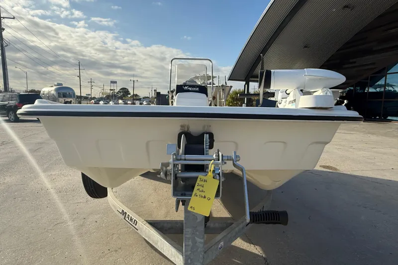 Slide: The Image of 2016 Mako Pro Skiff 17 CC boat on trailer, parked outdoors. - 3