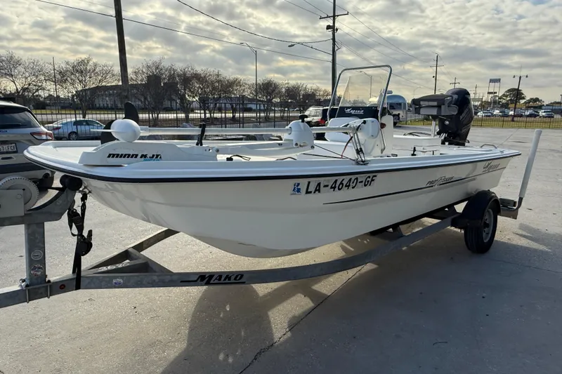 Slide: The Image of 2016 Mako Pro Skiff 17 CC boat on trailer in parking lot. - 4