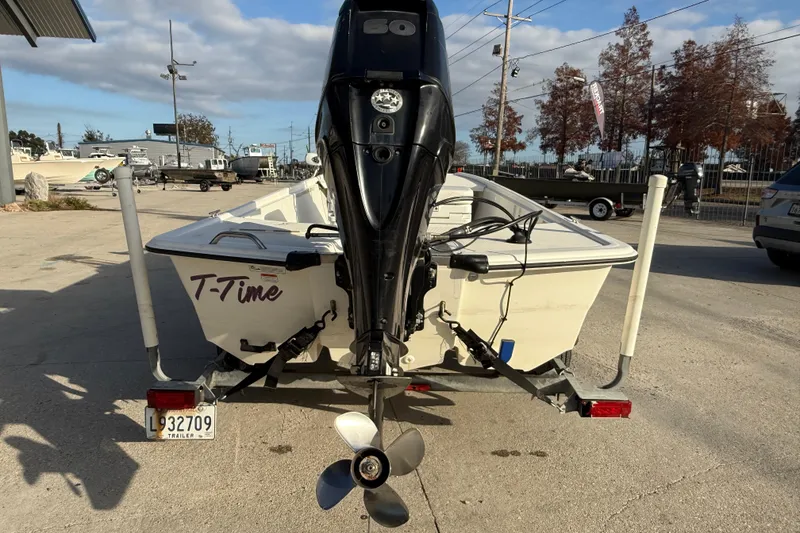 Slide: The Image of 2016 Mako Pro Skiff 17 CC boat on trailer, rear view with outboard motor. - 6