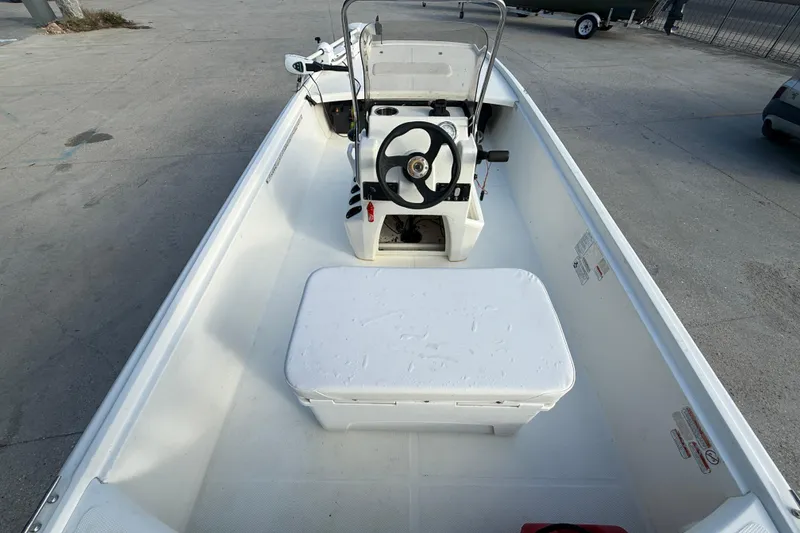 Slide: The Image of 2016 Mako Pro Skiff 17 CC boat interior with steering console and seating. - 8