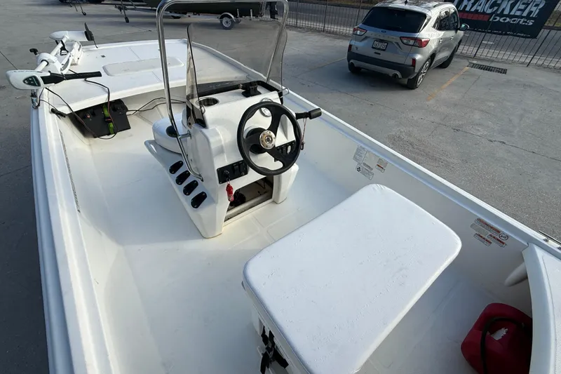 Slide: The Image of 2016 Mako Pro Skiff 17 CC boat interior with steering console and seating. - 9