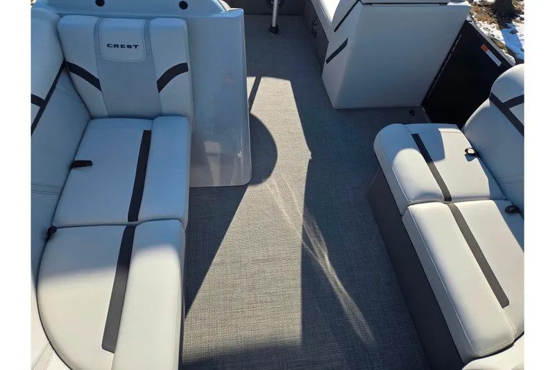 Slide: The Image of 2023 Crest Classic LX 200 boat interior with gray seating and carpet flooring. - 10