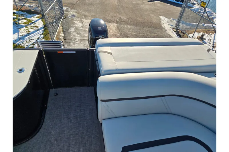 Slide: The Image of 2023 Crest Classic LX 200 boat interior with plush seating and outboard motor. - 16