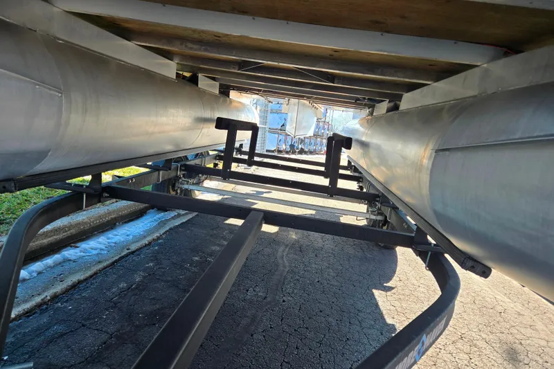 Slide: The Image of Underneath view of 2023 Crest Classic LX 200 pontoon boat on trailer. - 7