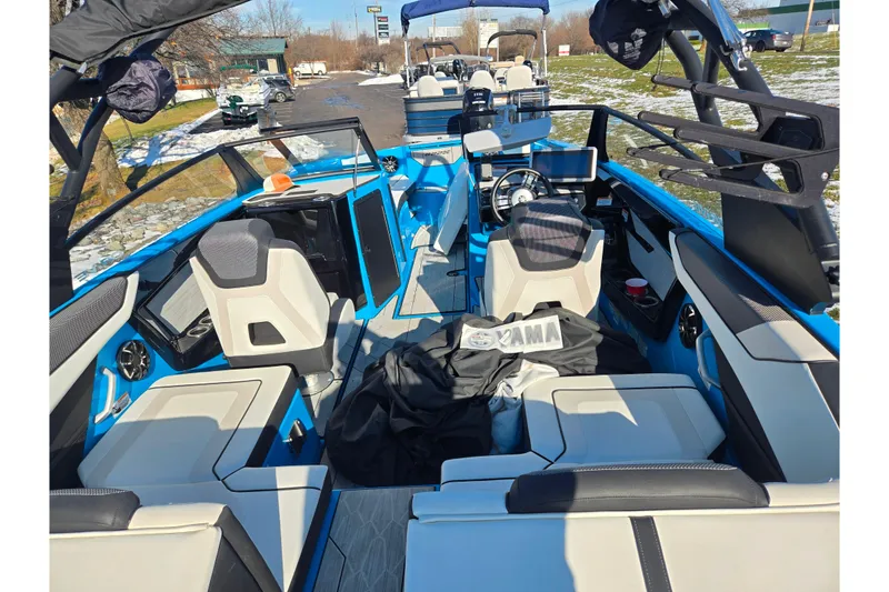 Slide: The Image of 2023 Yamaha Boats 222XD interior, featuring modern seating and controls, in a vibrant blue finish. - 10