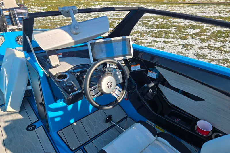 Slide: The Image of 2023 Yamaha Boats 222XD cockpit with steering wheel, touchscreen, and modern controls. - 14
