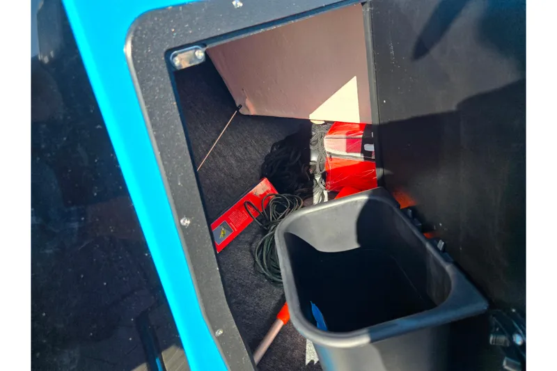 Slide: The Image of Storage compartment of 2023 Yamaha Boats 222XD with equipment and accessories. - 17