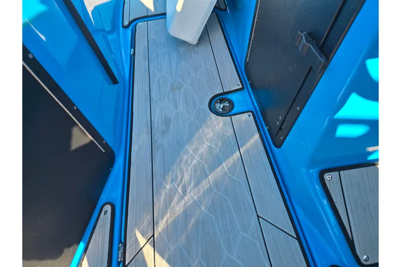 Slide: The Image of 2023 Yamaha Boats 222XD interior with sleek blue and gray deck design. - 18