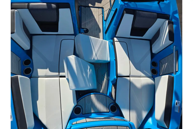 Slide: The Image of 2023 Yamaha Boats 222XD interior with blue and white seating, cup holders, and modern design. - 22