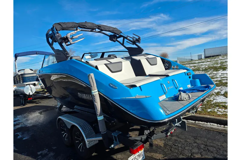 Slide: The Image of 2023 Yamaha Boats 222XD in blue, parked on a trailer, under a clear sky. - 3