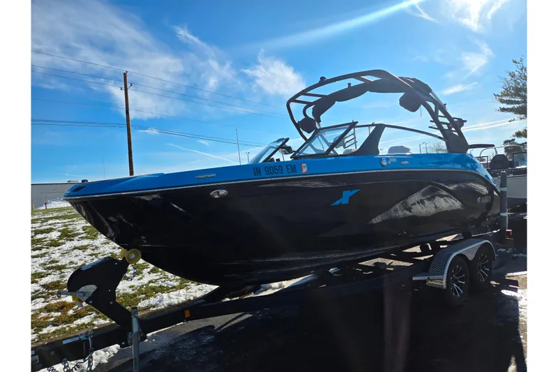 Slide: The Image of 2023 Yamaha Boats 222XD on trailer under clear blue sky. - 5