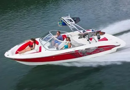 The Image of 2013 Bayliner 215 Bowrider boat on trailer, parked outdoors. - 0