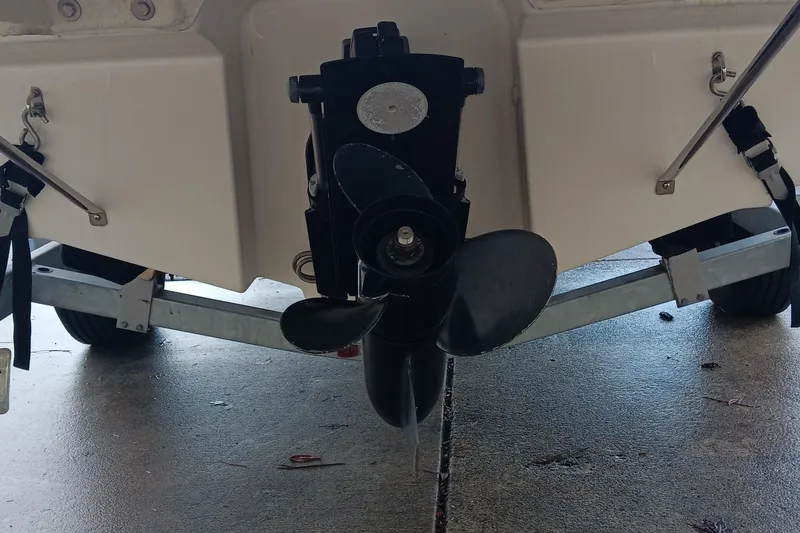 Slide: The Image of 2013 Bayliner 215 Bowrider boat propeller and trailer close-up. - 13