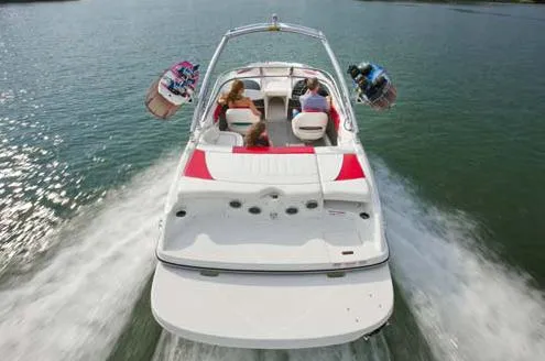 Slide: The Image of 2013 Bayliner 215 Bowrider on trailer, rear view, parked outdoors. - 2