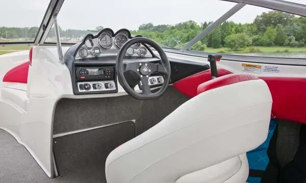 Slide: The Image of 2013 Bayliner 215 Bowrider interior with white and gray seating, showing wear and water droplets. - 6