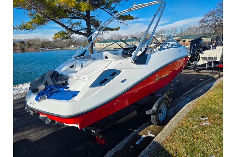 Slide: The Image of 2011 Sea-Doo 180 Challenger SE boat on trailer by a lake. - 1