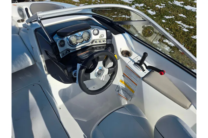 Slide: The Image of 2011 Sea-Doo 180 Challenger SE dashboard with steering wheel and controls. - 13