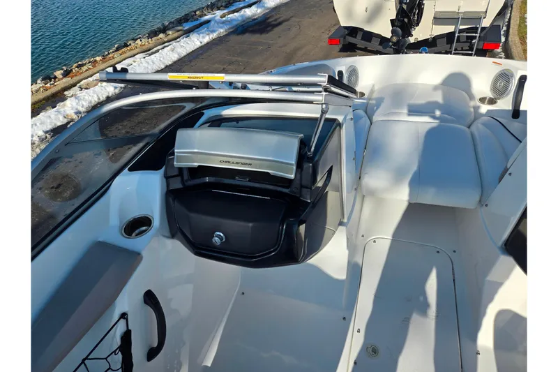 Slide: The Image of 2011 Sea-Doo 180 Challenger SE boat interior with seating and dashboard near water. - 14