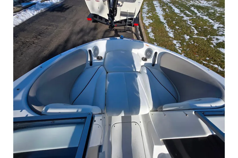 Slide: The Image of 2011 Sea-Doo 180 Challenger SE boat interior with white seating and cup holders. - 18