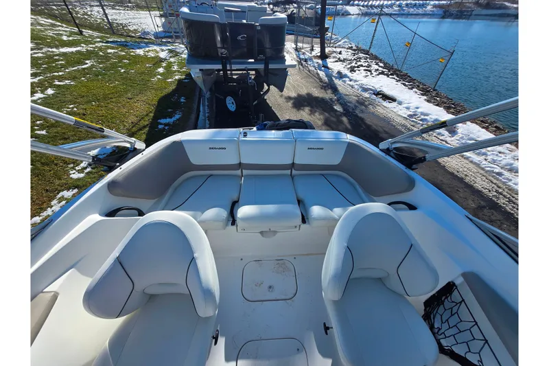 Slide: The Image of 2011 Sea-Doo 180 Challenger SE boat interior with seating, near a snowy lakeside. - 22