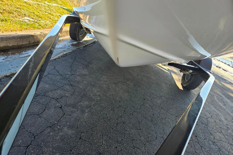 Slide: The Image of 2011 Sea-Doo 180 Challenger SE on trailer, close-up view of hull and wheels. - 7