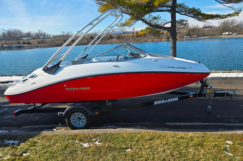 Slide: The Image of 2011 Sea-Doo 180 Challenger SE boat on trailer by a lake. - 9