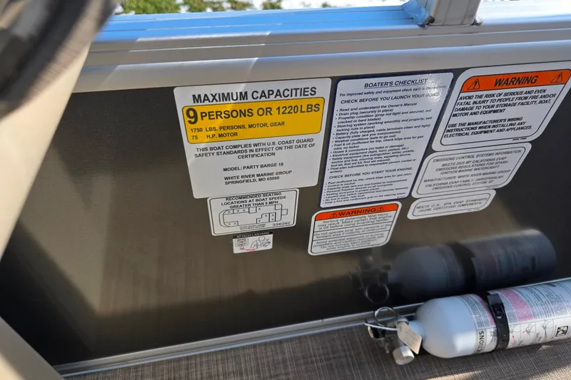 Slide: The Image of 2025 Sun Tracker Party Barge 18 DLX capacity and safety labels with fire extinguisher. - 14