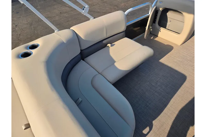 Slide: The Image of 2025 Sun Tracker Party Barge 18 DLX interior with beige seating and cup holders. - 18