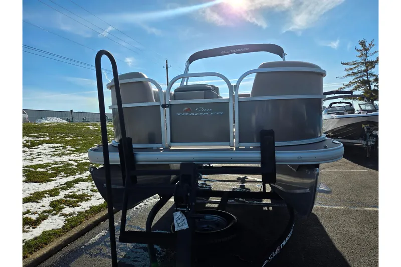 Slide: The Image of 2025 Sun Tracker Party Barge 18 DLX pontoon boat on trailer, sunny day. - 6