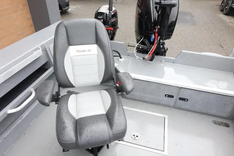 Slide: The Image of 2025 Thunder Jet 209 Rush OT boat interior with a cushioned seat and motor. - 10