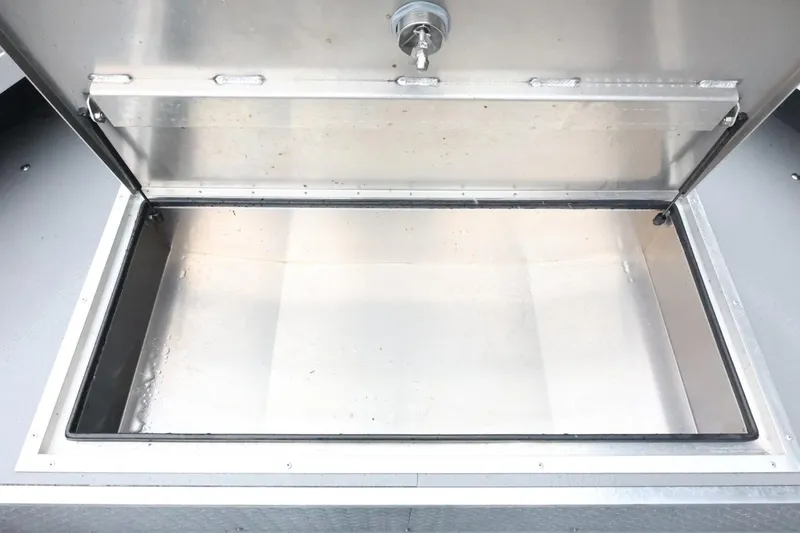 Slide: The Image of Open storage compartment in 2025 Thunder Jet 209 Rush OT boat. - 13