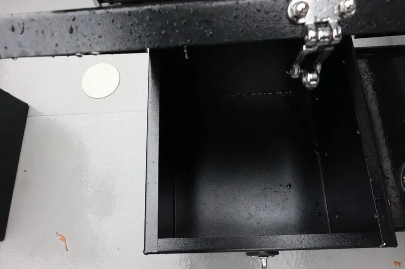 Slide: The Image of Open storage compartment on 2025 Thunder Jet 209 Rush OT boat, showing wet interior. - 17