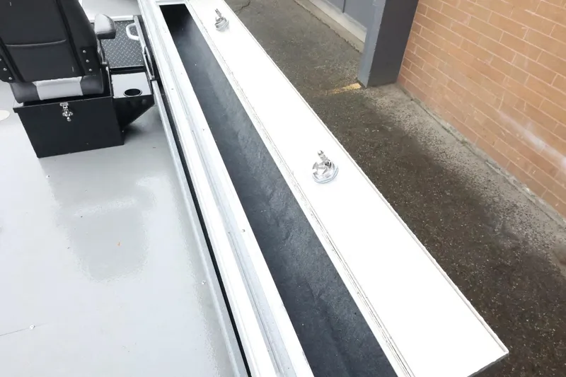 Slide: The Image of 2025 Thunder Jet 209 Rush OT boat interior with storage compartment and seating. - 18