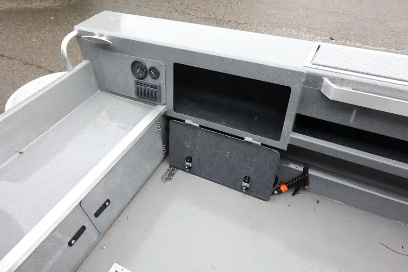 Slide: The Image of Interior view of 2025 Thunder Jet 209 Rush OT boat, featuring storage compartments and control panel. - 24