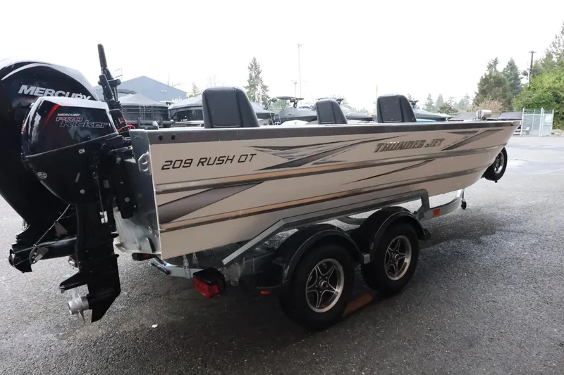 Slide: The Image of 2025 Thunder Jet 209 Rush OT boat on trailer with Mercury Pro Kicker engine. - 6
