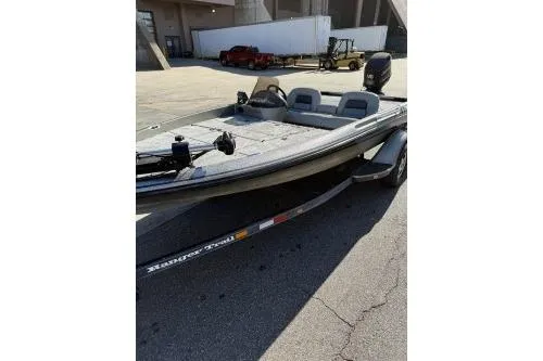 Slide: The Image of 1997 Ranger 461 VS Commanche boat on trailer, parked outdoors. - 2