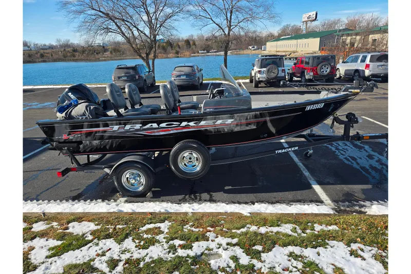 Slide: The Image of 2020 Tracker Pro Guide V-16 SC boat on trailer by a lake in winter. - 10