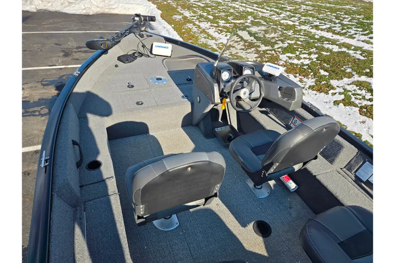 Slide: The Image of 2020 Tracker Pro Guide V-16 SC boat interior with steering console and seating. - 11