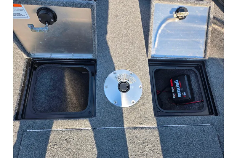 Slide: The Image of 2020 Tracker Pro Guide V-16 SC boat storage compartments with battery charger. - 17