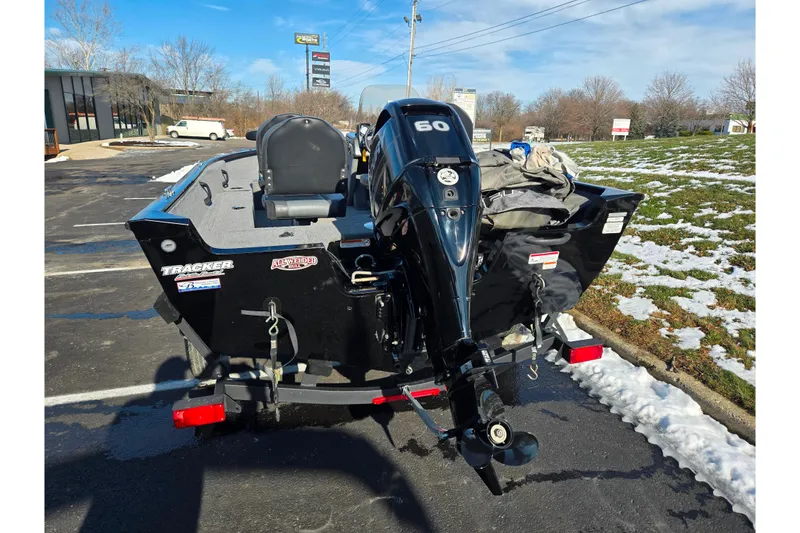 Slide: The Image of 2020 Tracker Pro Guide V-16 SC boat with 60 HP motor in parking lot. - 2