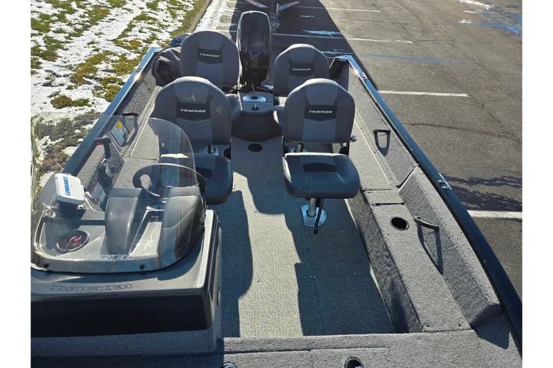 Slide: The Image of 2020 Tracker Pro Guide V-16 SC fishing boat with seating, parked on asphalt. - 21