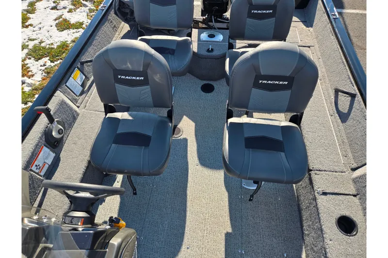 Slide: The Image of 2020 Tracker Pro Guide V-16 SC boat interior with gray seating and steering wheel. - 22