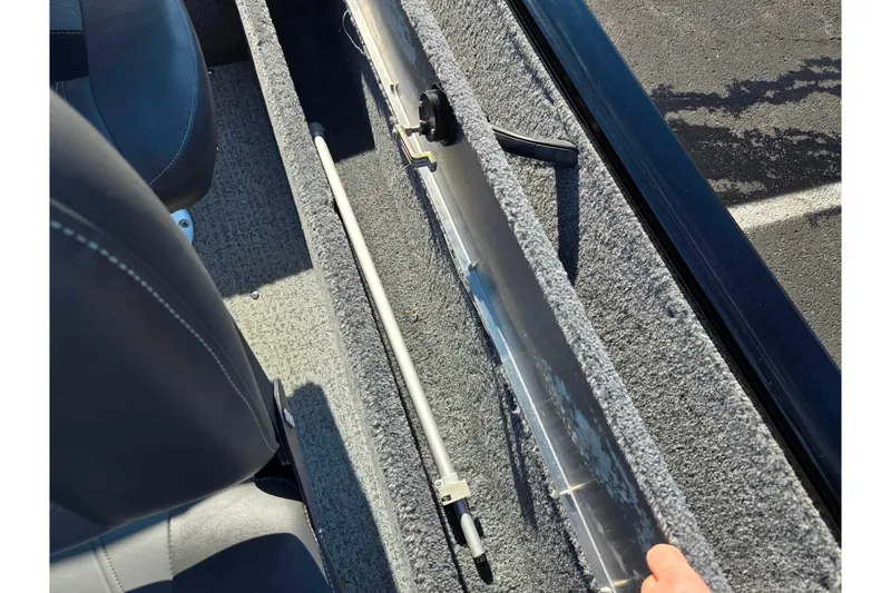 Slide: The Image of 2020 Tracker Pro Guide V-16 SC boat interior storage compartment with rod holder. - 23