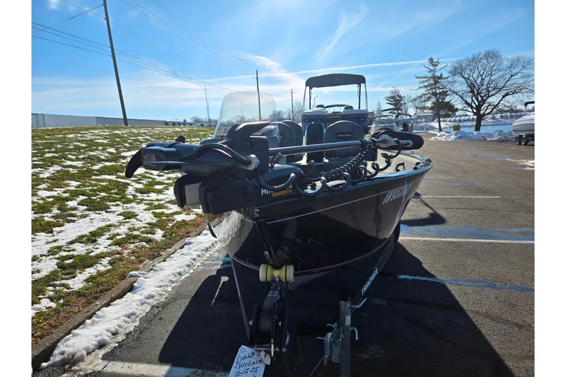 Slide: The Image of 2020 Tracker Pro Guide V-16 SC boat parked on snowy pavement under clear blue sky. - 7