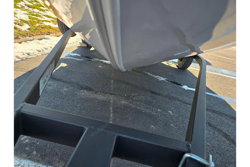 Slide: The Image of 2020 Tracker Pro Guide V-16 SC boat on trailer, parked on asphalt with snow nearby. - 8