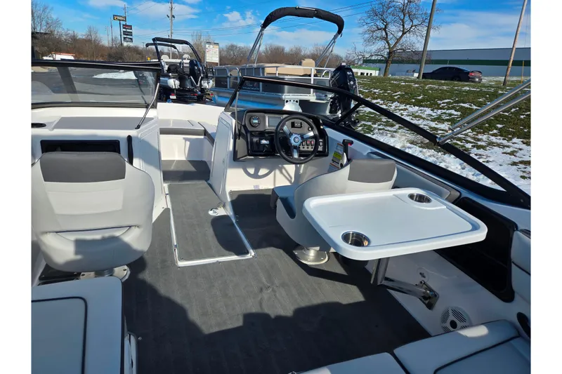 Slide: The Image of 2020 Yamaha Boats SX190 interior with steering wheel, seating, and table setup. - 10