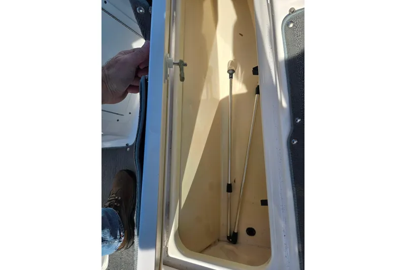 Slide: The Image of 2020 Yamaha Boats SX190 storage compartment with open hatch, showing interior details. - 14